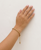 Gia Bracelet on wrist plaster wall