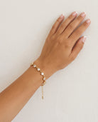 The Lune Bracelet on wrist plaster wall