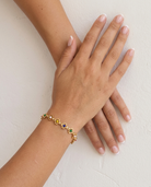 Soleil Rainbow Bracelet on wrist plaster wall