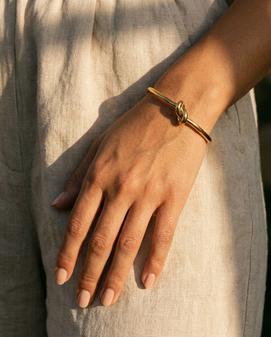 Elise Gold Knot Bangle warm on wrist