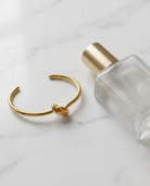 Elise Gold Knot Bangle marble flatlay