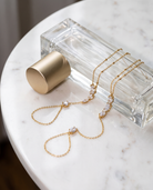 Nadia Hand Chain flatlay on white marble