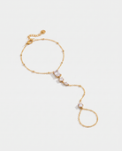 Nadia Hand Chain gold hand chain on light grey background