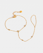 Pia Hand Chain gold hand chain on light grey background