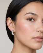 Laurel silver earrings worn on ear