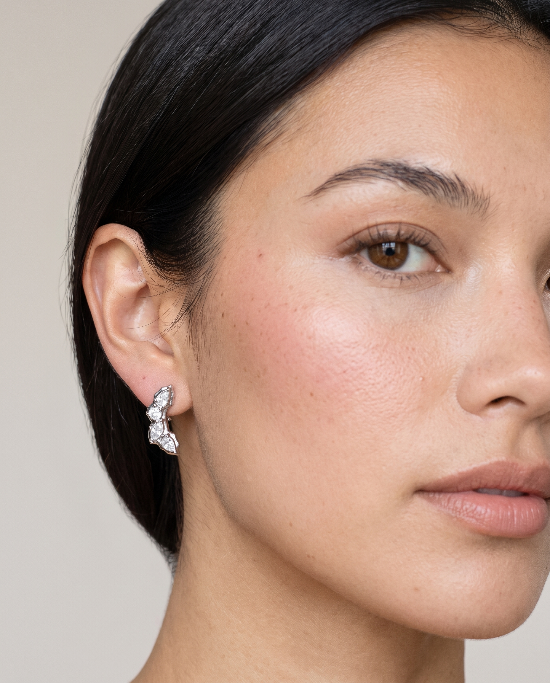 Laurel silver earrings worn on ear