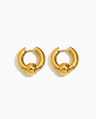 Solene chunky gold huggie hoop earrings pair on off white background