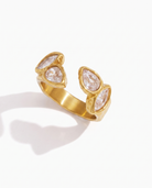 Agathe open zircon ring in 18k gold on off white background