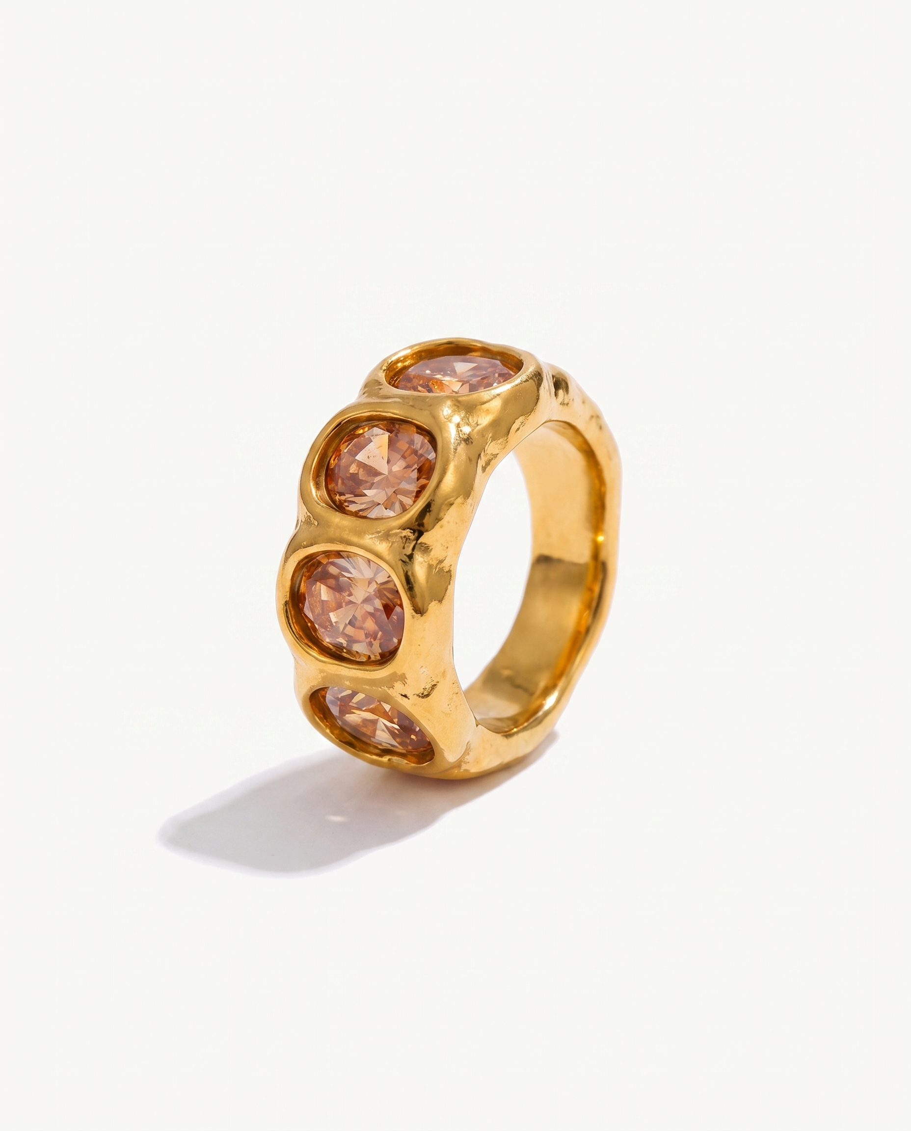 Clemence champagne zircon band ring in 18k gold on off white background