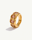 Clemence champagne zircon band ring in 18k gold on off white background