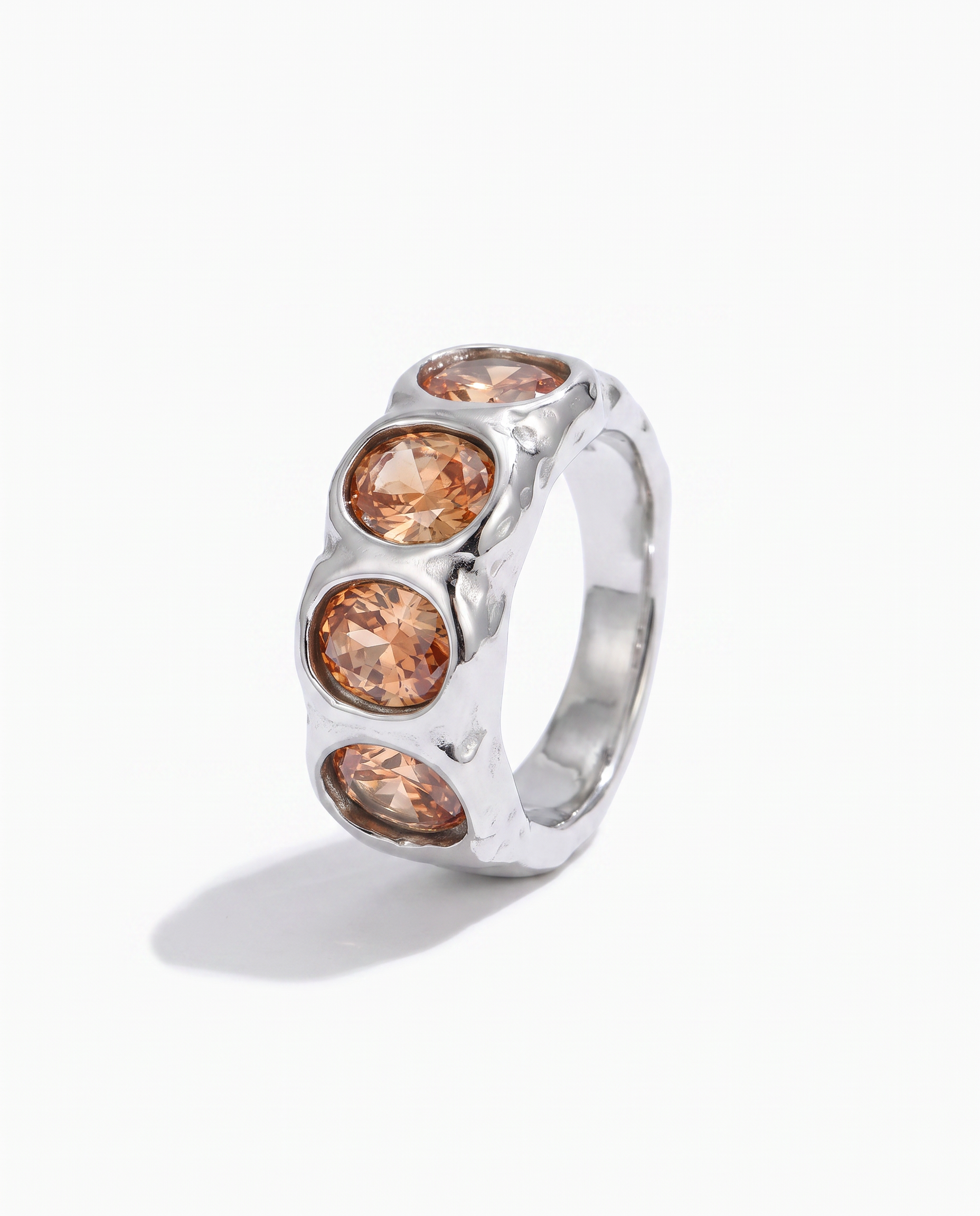 Clemence champagne zircon band ring in silver on off white background