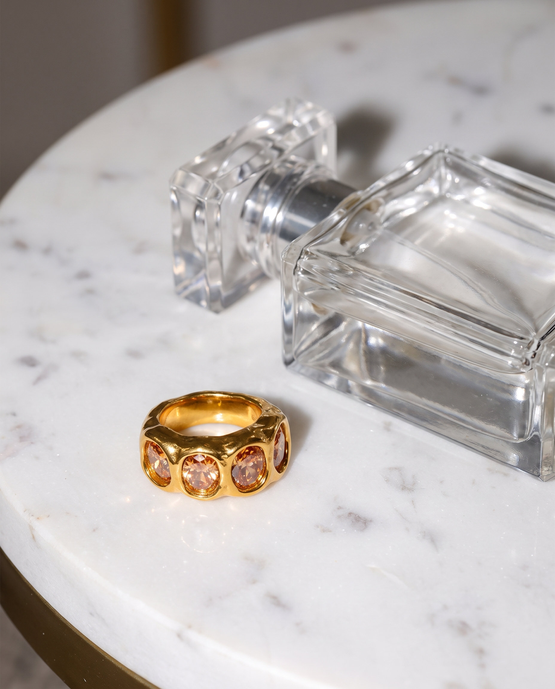 Clemence gold champagne zircon ring flatlay on marble