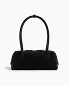 Salome suede baguette shoulder bag in black on off white background
