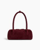 Salome suede baguette shoulder bag in burgundy on off white background