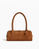 Salome suede baguette shoulder bag in cognac on off white background