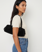 Salome black suede baguette bag worn under the arm