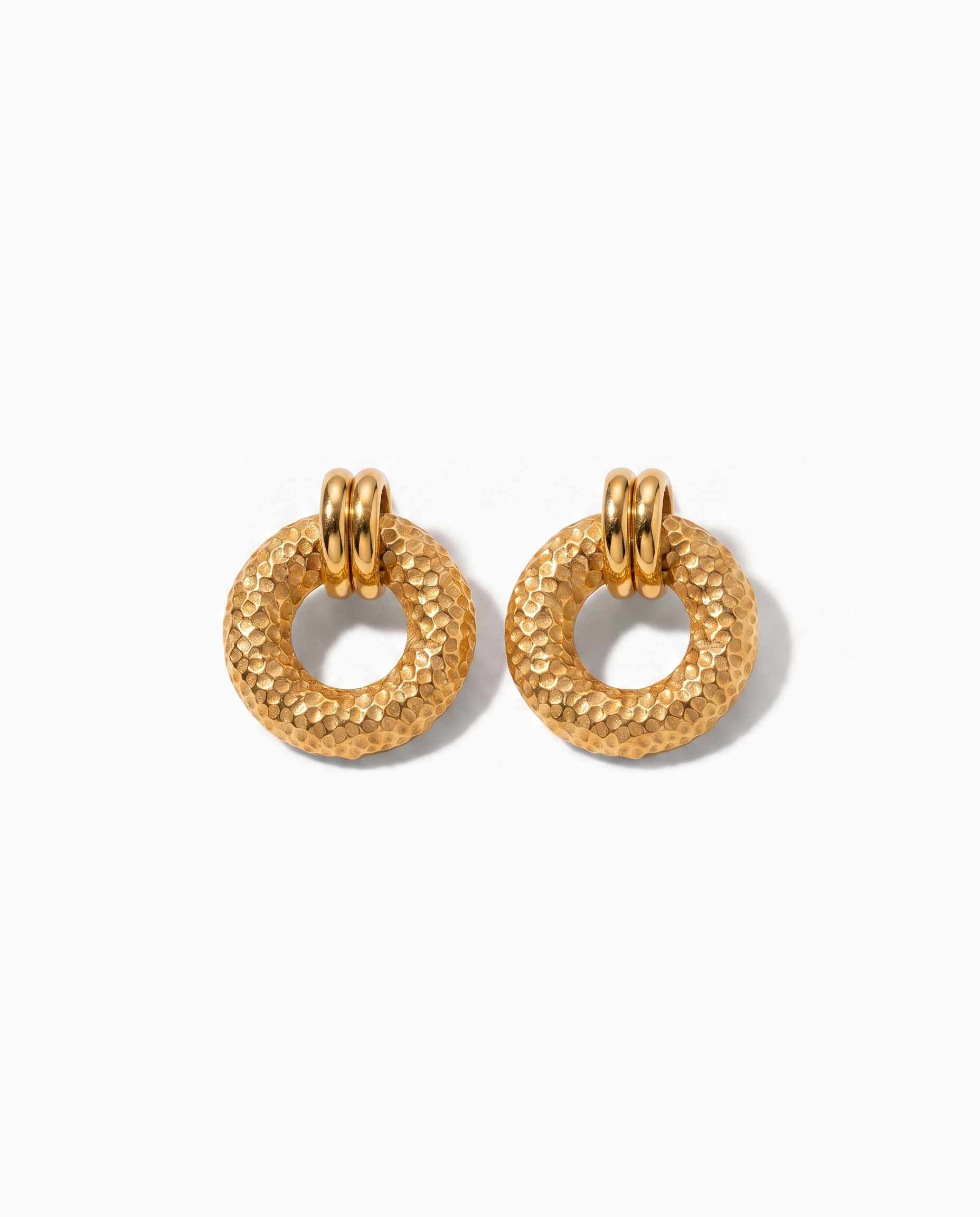 Cleo hammered gold disc earrings pair on off white background