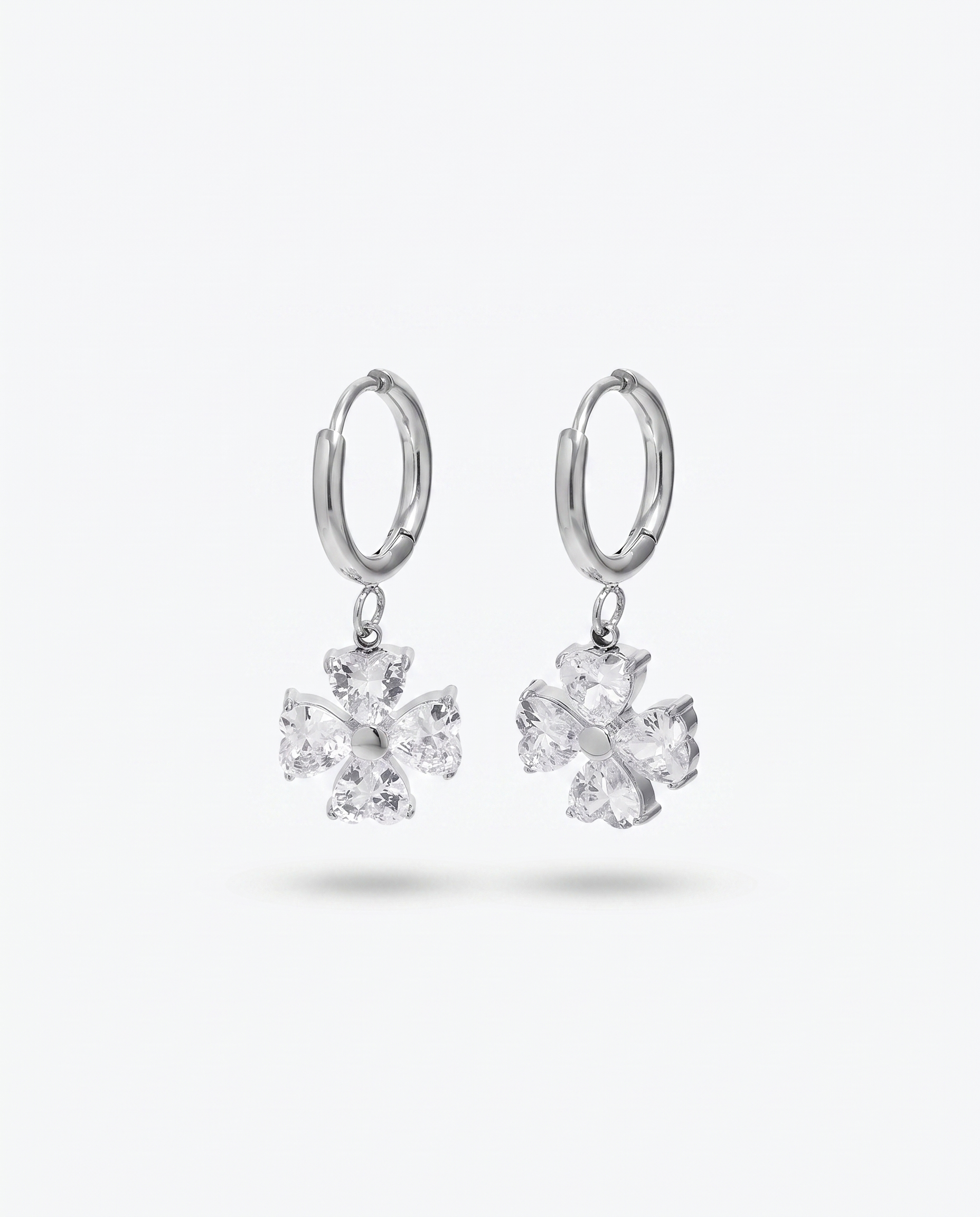 Trefle four leaf clover heart zircon silver hoop earrings pair on off white background
