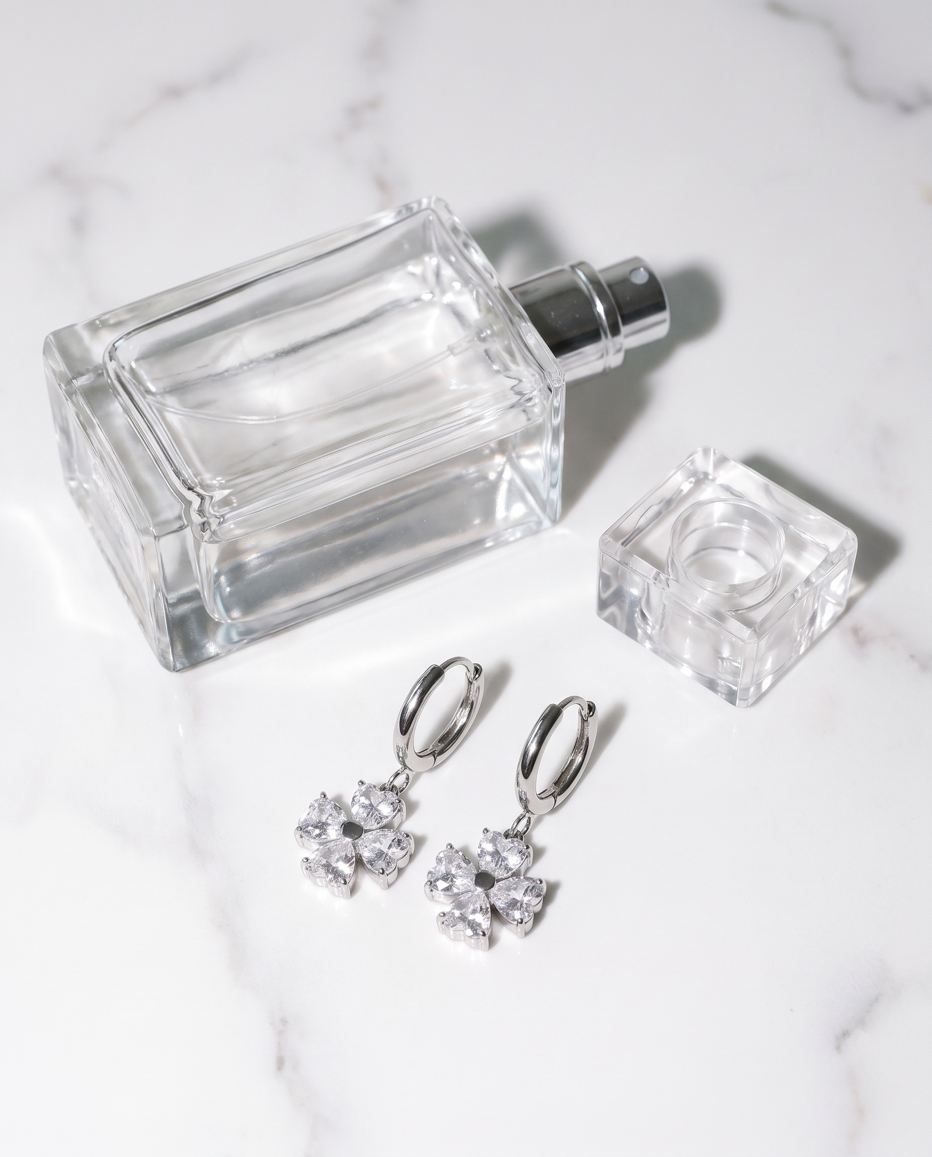 Trefle silver clover earrings flatlay on marble
