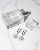 Trefle silver clover earrings flatlay on marble