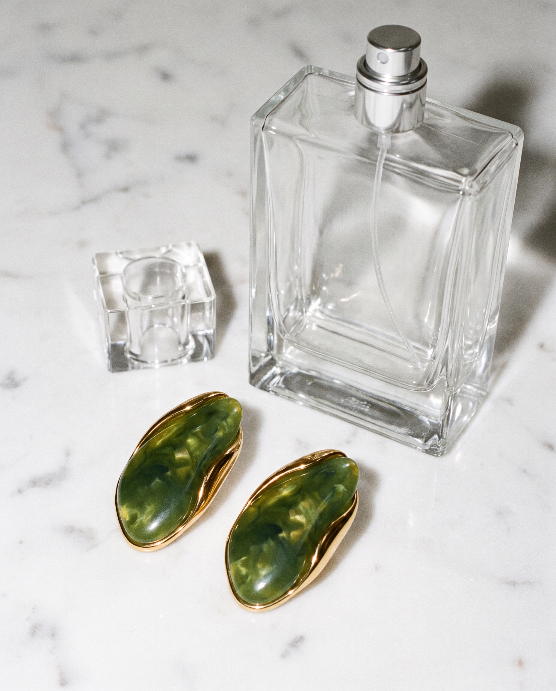 Galet jade pebble studs flatlay on marble