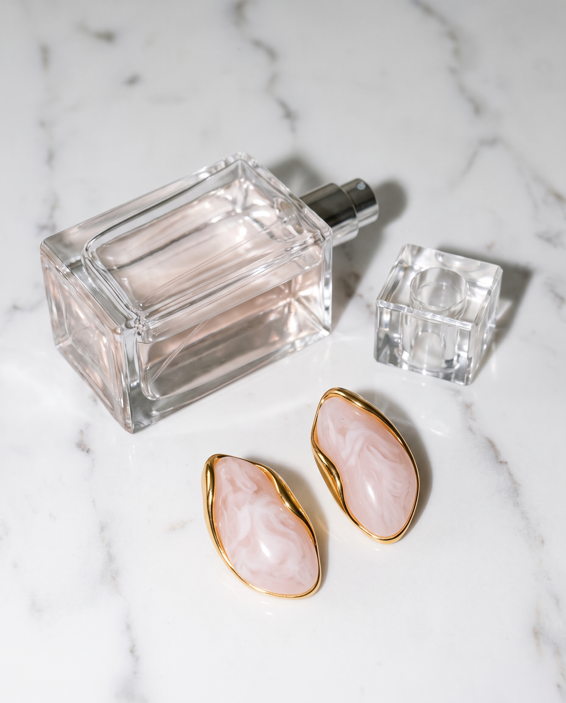 Galet blush pebble studs flatlay on marble