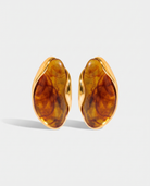 Galet amber pebble studs pair on off white background