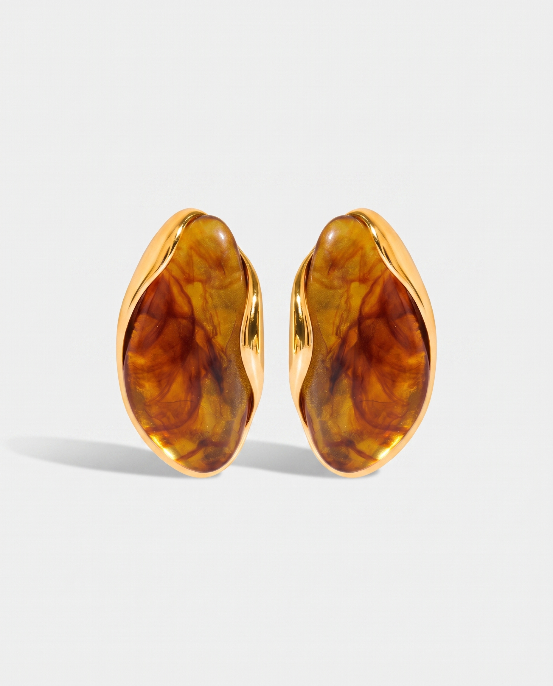 Galet amber pebble studs pair on off white background