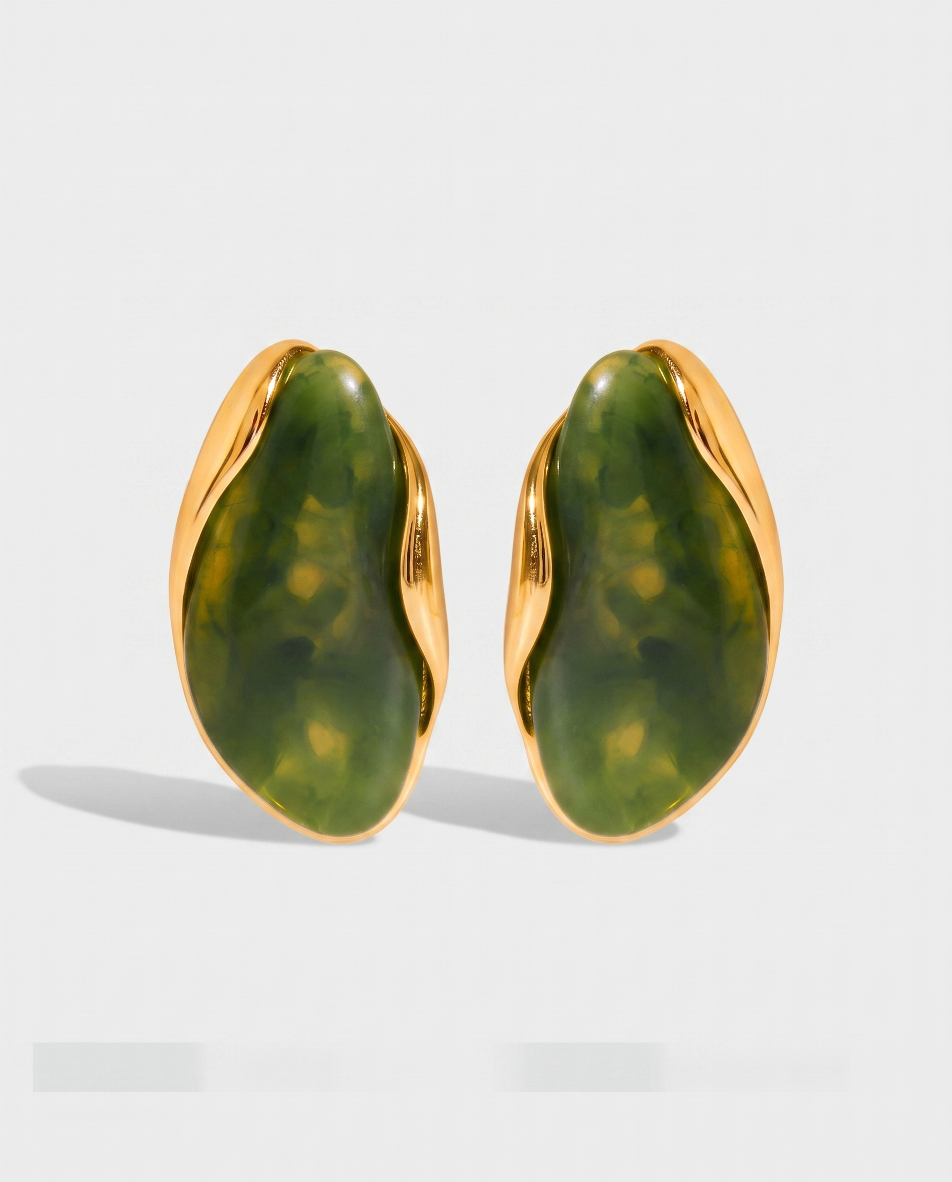 Galet jade pebble studs pair on off white background