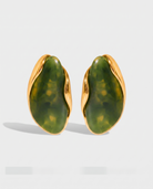 Galet jade pebble studs pair on off white background