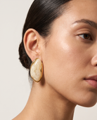 Galet cream pebble studs worn on model
