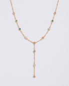 Prisme multicoloured zircon Y-lariat gold necklace on off white background