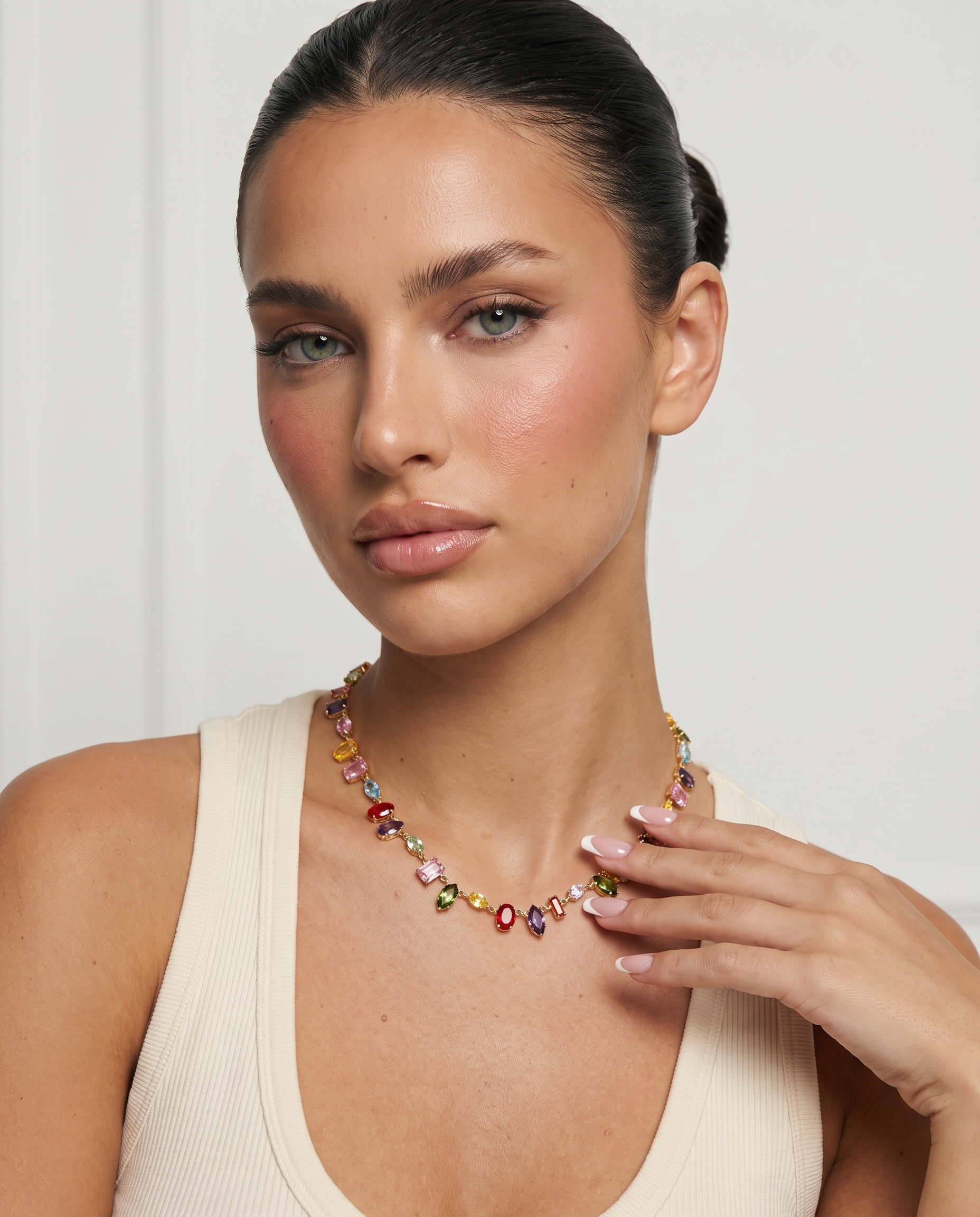 Iris colourful crystal necklace hand to collarbone pose on model