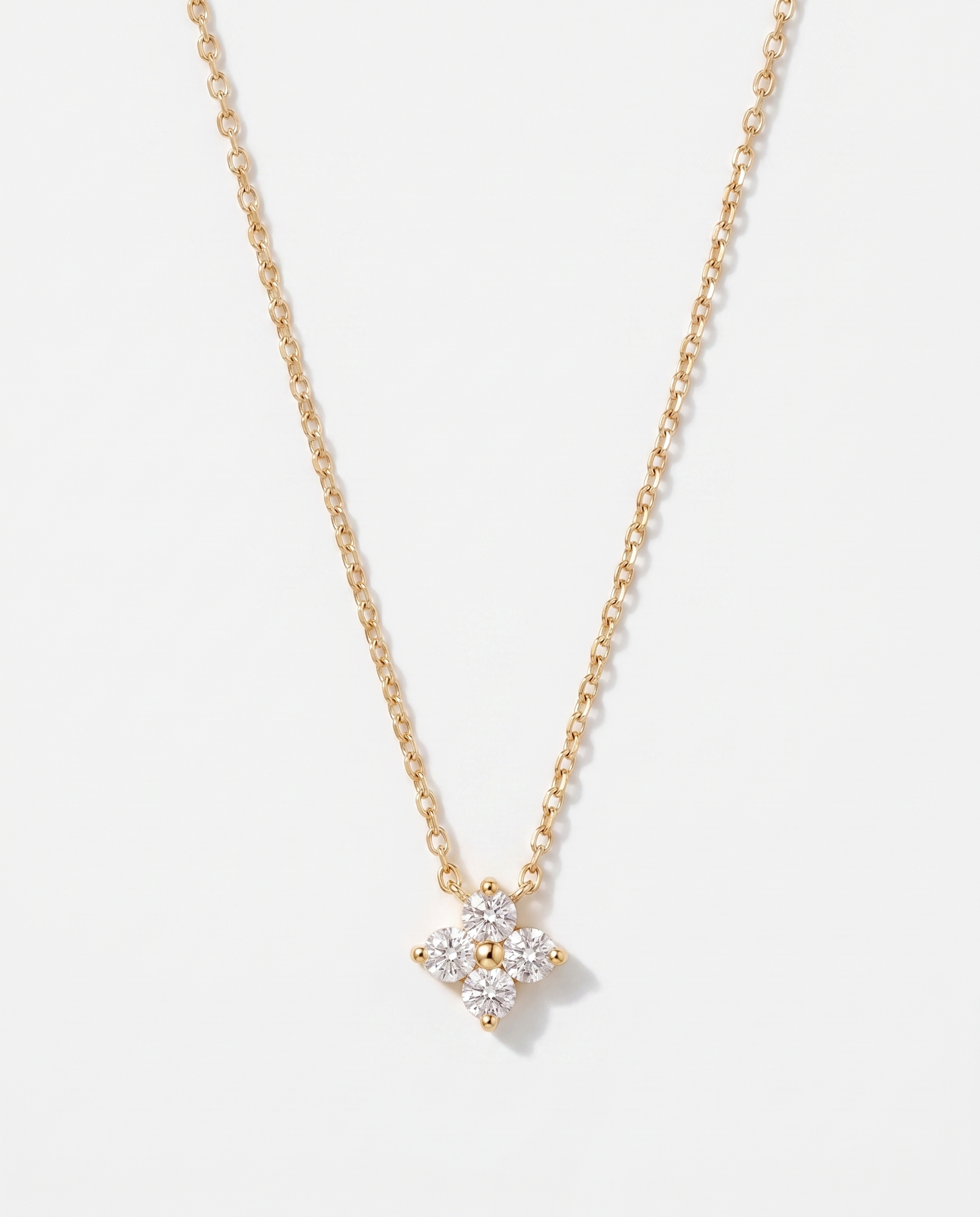 Fleur four-leaf flower zircon gold pendant necklace on soft studio background