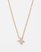 Fleur four-leaf flower zircon gold pendant necklace on soft studio background