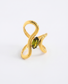 Jade green crystal irregular gold ring on soft studio background