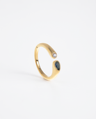 Birthstone ring September blue sapphire gold on soft studio background