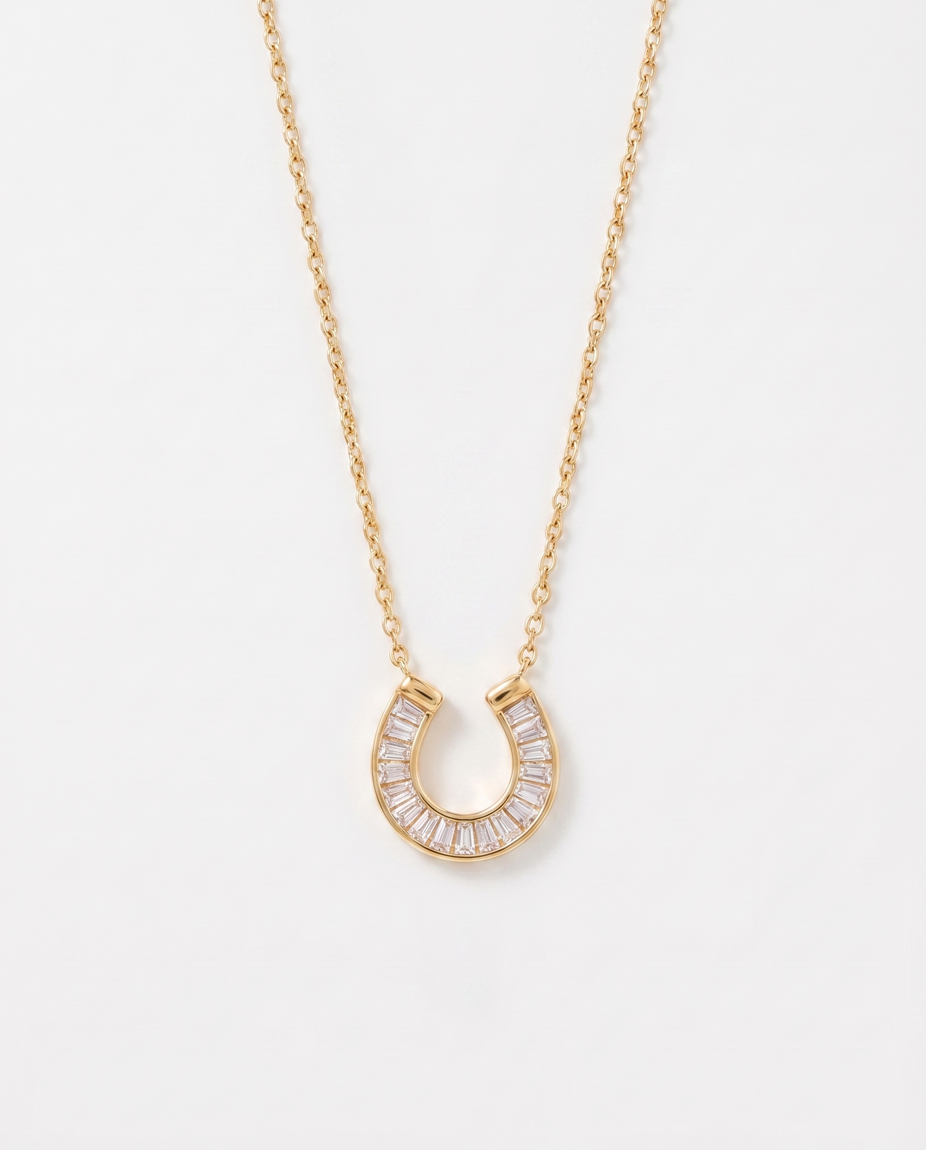 Lucky horseshoe cubic zirconia gold necklace on soft studio background