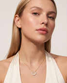 Lucky horseshoe necklace worn on model at the collarbone