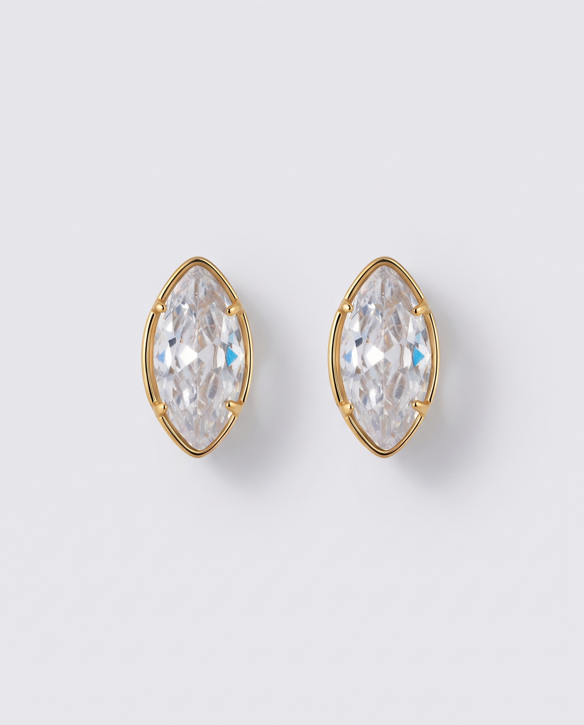 Margaux heart zircon gold stud earrings on off white background