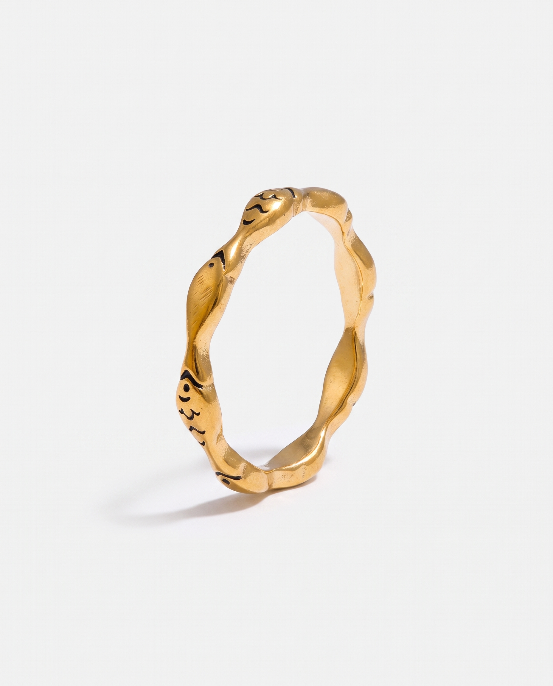 Poisson gold fish ring on off white background