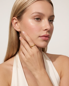 Poisson fish ring worn on model hand to cheek